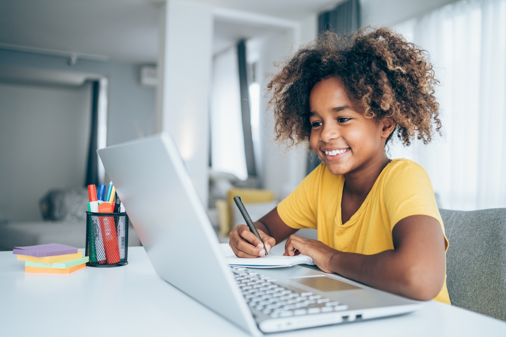 Student working at a table and computer